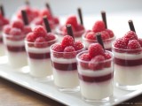 berry panna cotta with fresh raspberries and chocolate sticks is gorgeous for a summer or fall wedding
