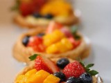 mini tarts with peaches, strawberries and blueberries plus custard are delicious for a summer wedding