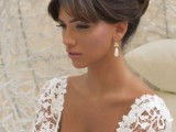 a formal updo with a bump, a top braided knot, bangs is a stylish and elegant idea