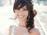 a wavy side half updo with bangs and a bump is a chic idea with a touch of vintage