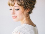 a full fringe bang with a retro-inspired updo and matching makeup for a retro-inspired wedding