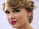 a wavy low updo with bangs is a stylish retro hairstyle for elegant and refined brides