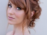 a romantic wavy updo with a bump and side bangs is a timeless idea with a vintage feel