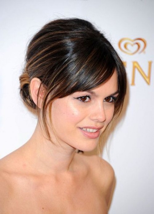 a low updo on medium length hair with side bangs is a cool idea to pull off an elegant look