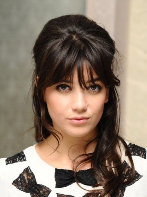 a long and wavy half updo with bangs ad a bump is a chic idea for long or medium length hair