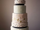a whimsical polka dot wedding cake with white, pastel green and pink tiers, large and small polka dots and ribbons is a chic and lovely solution for a spring wedding