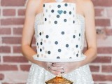 a white wedding cake decorated with colorful polka dots and topped with a silver heart is a lovely idea for a modern wedding with a restraint color palette
