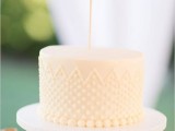 a neutral polka dot wedding cake with a calligraphy cake topper is a modern and fresh idea for a spring or summer wedding