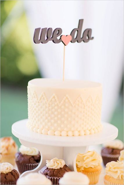 a neutral polka dot wedding cake with a calligraphy cake topper is a modern and fresh idea for a spring or summer wedding