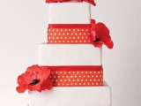 a white and red square wedding cake with ribbons, red blooms on top is a lovely idea for a summer wedding with touches of red