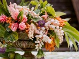 a lush floral centerpiece plus bananas is suitable for a tropical or beach wedding