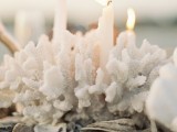 corals and seashells plus candles inserted into corals is a very dreamy beachy or coastal wedding centerpiece