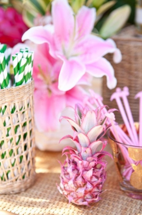 a pink tropical bloom centerpiece with a pink pineapple is a fun idea for a tropical wedding