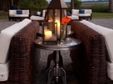 an outdoor wedding lounge with wicker furniture, white upholstery, coffee tables and lanterns is a lovely space to enjoy