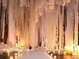a dreamy white fabric ribbons, fabric and paper ribbons backdrop plus candles on the floor