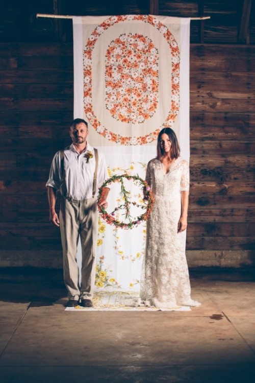 a curtain with painted blooms is a cool idea for a free-spirited indoor wedding, you can also embroider them if you want