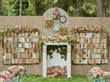 a whimsical wedding backdrop with vintage books, blooms, greenery, a fake fireplace and clocks is a beautiful idea for a vintage tea party wedding