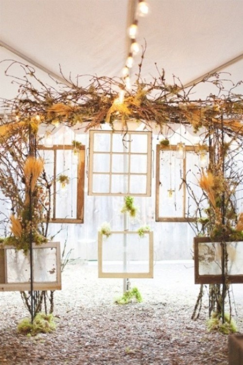 a cool wedding backdrop of vintage frames, window frames, dried blooms and herbs and vines