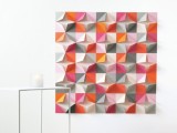 a bright paper geometric backdrop with lots of colors to fit a colorful wedding with a modern twist