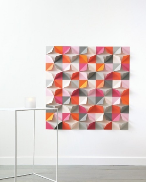 a bright paper geometric backdrop with lots of colors to fit a colorful wedding with a modern twist