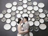 a wedding backdrop made of vintage plates in grey and white and with various patterns is a very chic idea