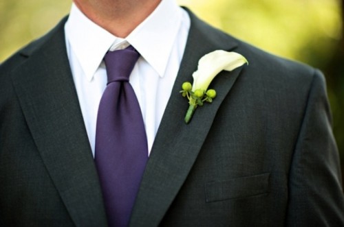 a black suit, a white shirt and a purple tie for a bold and chic look