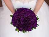 a deep purple wedding bouquet with touches of green