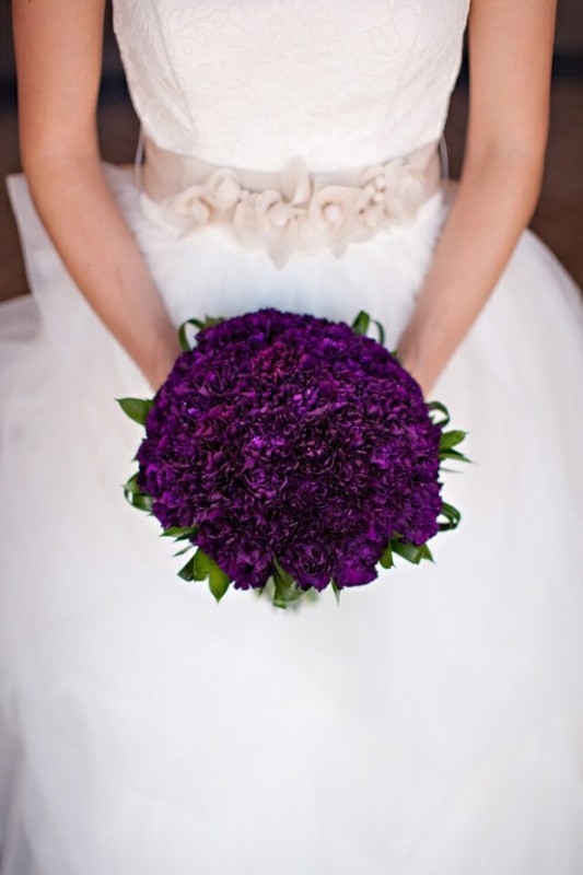 A deep purple wedding bouquet with touches of green