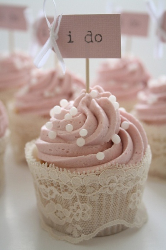 a pink cupcake with sugar pearls and a lace liner plus a small cupcake topper is a lovely idea not only for a bridal shower but also for a wedding
