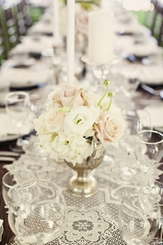 a white lace table runner and white blooms are a great combo for a vintage or rustic wedding