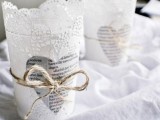 lace candleholders with newspaper hearts and twine are adorable for a vintage wedding, and you may DIY them