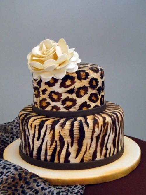 a bold wedding cake with a leopard and a zebra tier, with a sugar bloom on top is a lovely idea for a safari wedding