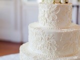 a white lace wedding cake topped with fresh white blooms is a beautiful and stylish idea