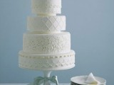 a white lace wedding cake with floral or botanical decor is a stylish idea with an elegant feel