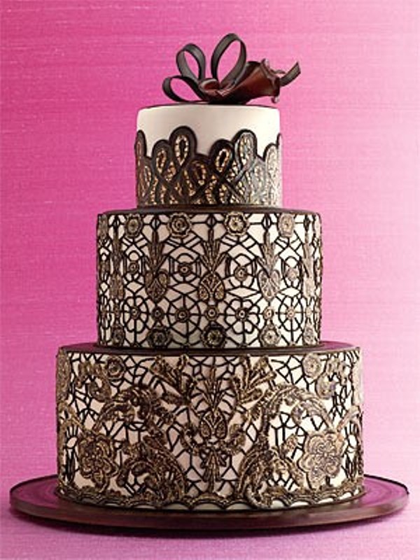 A black and white lace wedding cake with a chocolate bow on top is a very chic idea with a refined feel