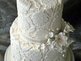 a neutral lace floral wedding cake with ribbons and sugar flowers is a beautiful and elegant idea