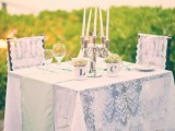 accent your sweetheart table with a table runner, a candelabra and some greenery in mugs with your monograms