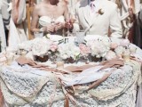 a lace tablecloth, lots of ribbons that match in color and a table runner of white and pink blooms plus candles