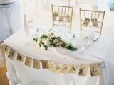 a paper bunting, candles and a lush floral centerpiece will make your sweetheart table stand out but not too much
