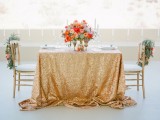 a gold sequin tablecloth, a lush and bold floral centerpiece and chairs decorated with bright blooms and air plants will highlight your space