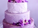 a beautiful ombre wedding cake from light pink to lilac and purple, with matching purple blooms is a gorgeous idea for a spring or summer wedding