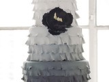 an ombre wedding cake with white to light grey and graphite grey fringe tiers, with a black bloom is a catchy and stylish solution for a modern wedding