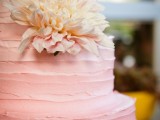 an ombre white to pink textural buttercream wedding cake decorated with a single neutral bloom is a chic idea for a spring or summer wedding
