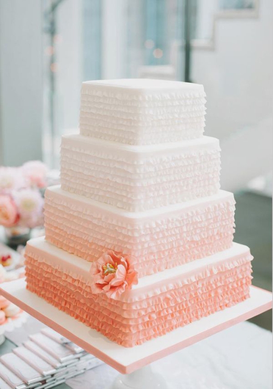 a ruffle square ombre wedding cake from white to orange, with matching orange blooms is a bold and cool idea for summer