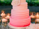 a stylish ombre pink textural buttercream wedding cake with a large sugar bloom is a pretty idea for a colorful spring or summer wedding