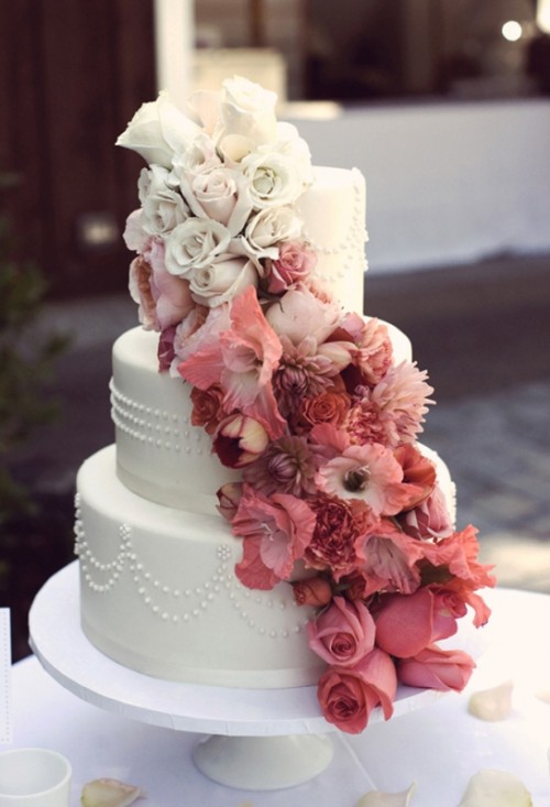 a white buttercream wedding cake with patterns and ombre blooms from white to burgundy is a lovely idea for a contrasting wedding