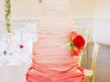 a bright ombre wedding cake from white to hot red plus hot red blooms is a bold and catchy solution for a summer wedding