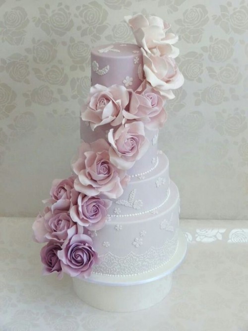 a refined and delicate lilac wedding cake with ombre floral decor from light pink to lilac and purple is a chic idea for a spring wedding with a vintage feel