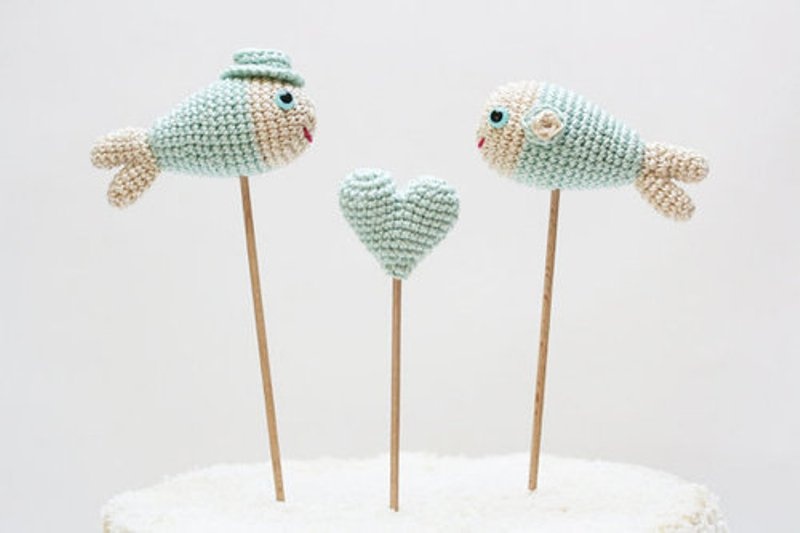 Knit mint colored fish and heart cake toppers are very whimsy and super cute