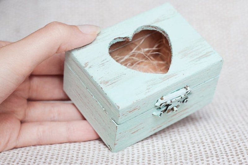 A shabby chic mint box with a cutout heart can be used to display wedding rings or for wedding decor
